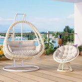 Pink metal 2-seater porch swing with stand, chain, and cushions for outdoor seating
